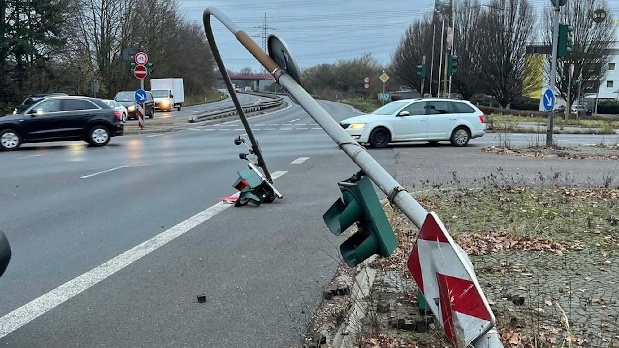 Ein umgefahrener Ampelmast liegt auf einer Kreuzung in Frechen auf der Straße.