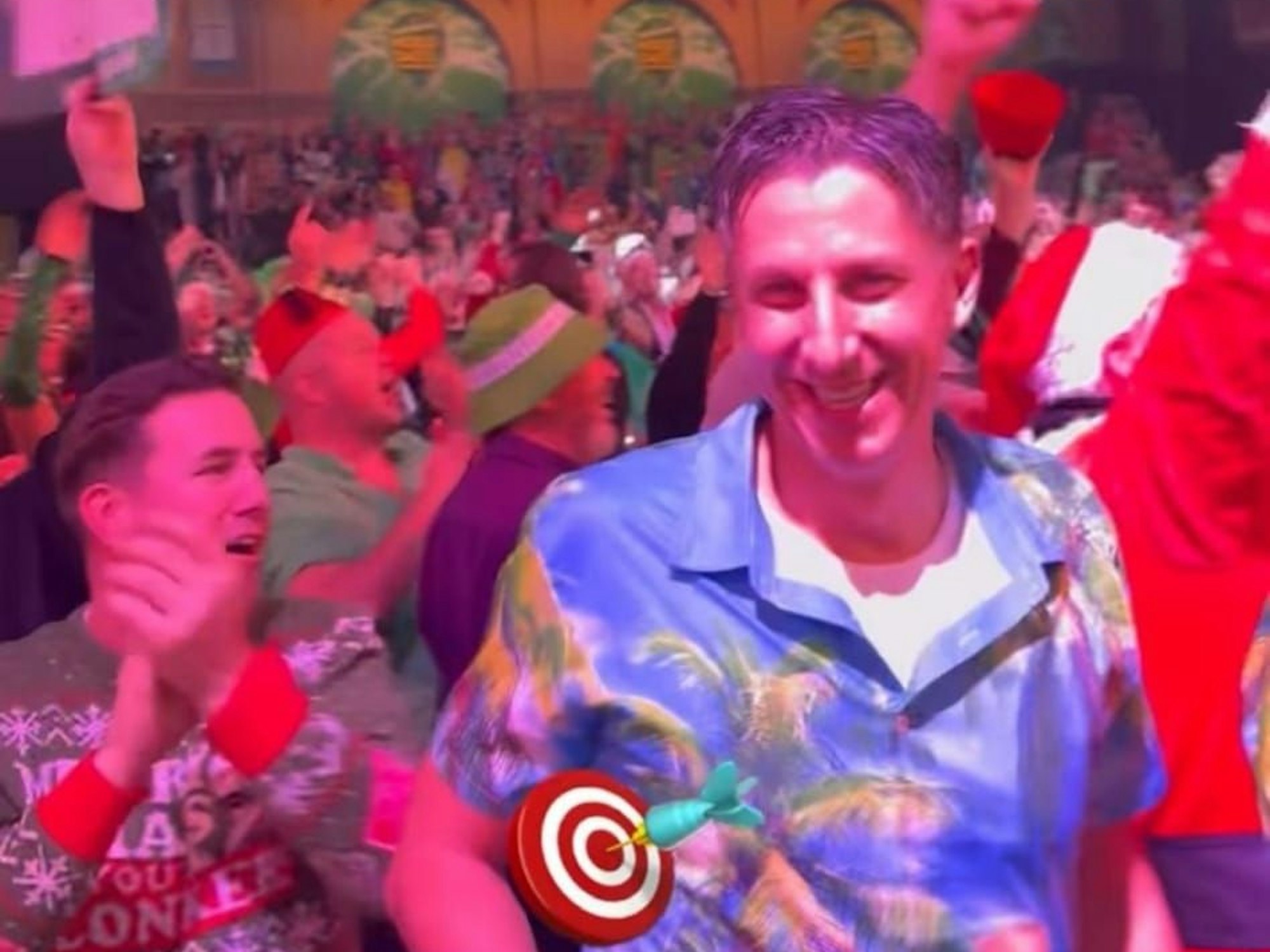 Christian Keller trägt ein blaues Hawaii-Hemd und lacht in die Kamera.