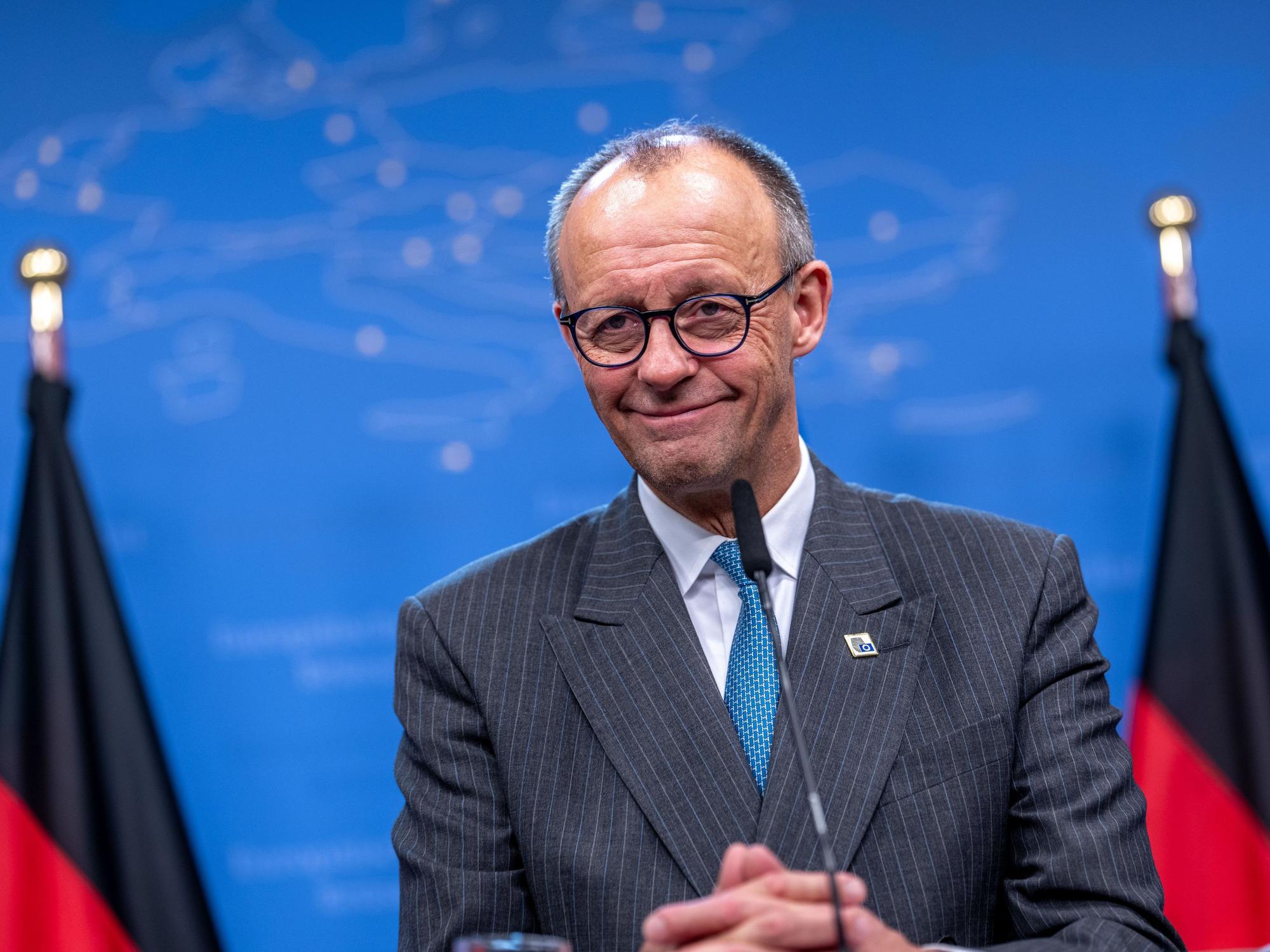 Bundeskanzler Friedrich Merz (CDU) steht vor einem Mikrofon.