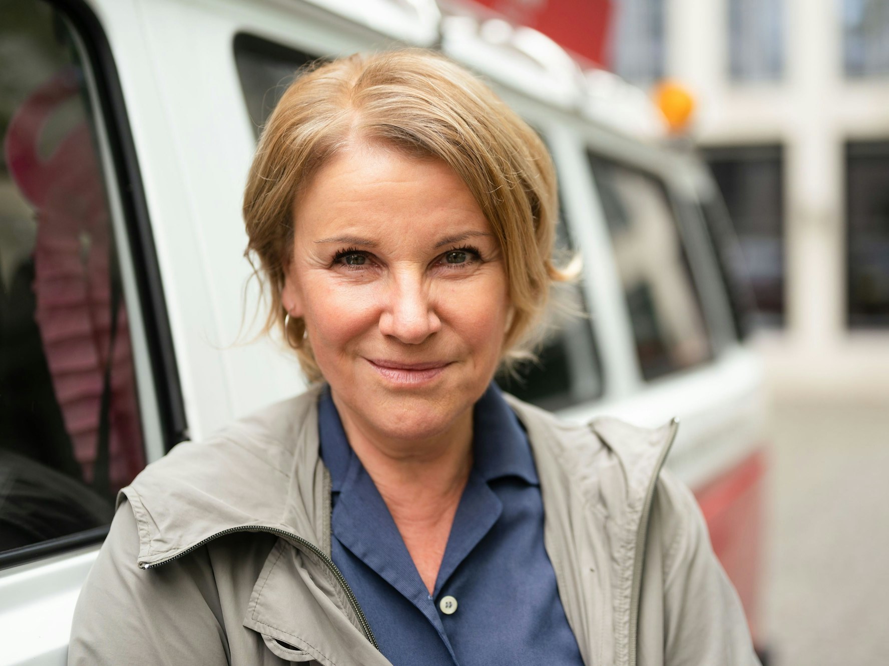 Schauspielerin Mariele Millowitsch steht neben einem Bulli.