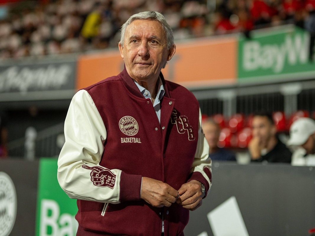 Svetislav Pesic trägt eine College-Jacke des 1. FC Köln.