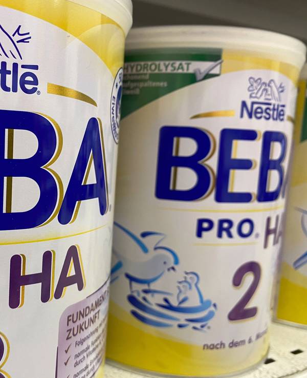Viersen, Germany - July 9. 2020: View on isolated can nestle beba baby food in shelf of german supermarket (focus on left can)