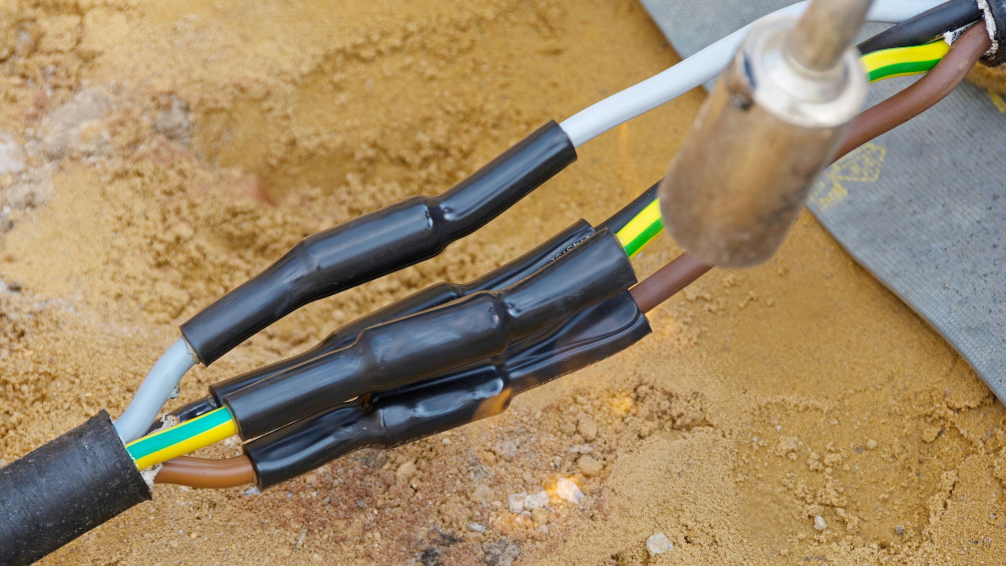 Elektriker bei der Reparatur von Stromkabeln