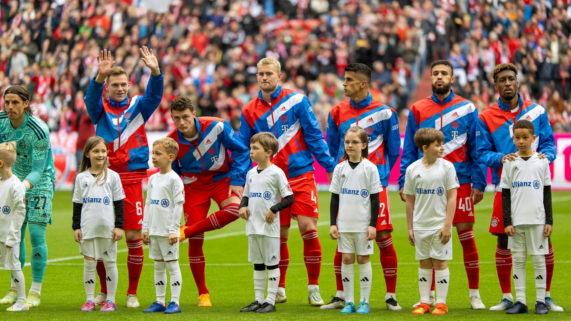 Joao Cancelo steht mit Teamkollegen vom FC Bayern nebeneinander auf dem Platz.