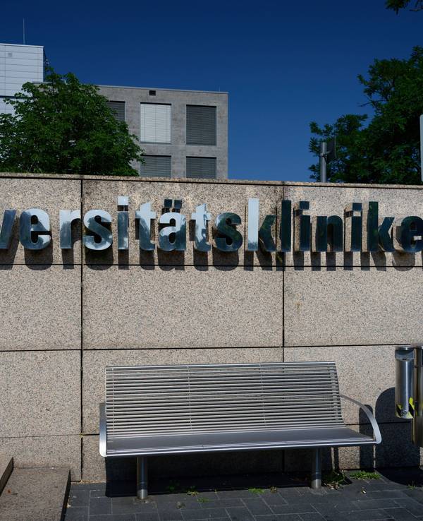 Schriftzug auf einer Steinmauer am Haupteingang des Universitätsklinikums in Köln.