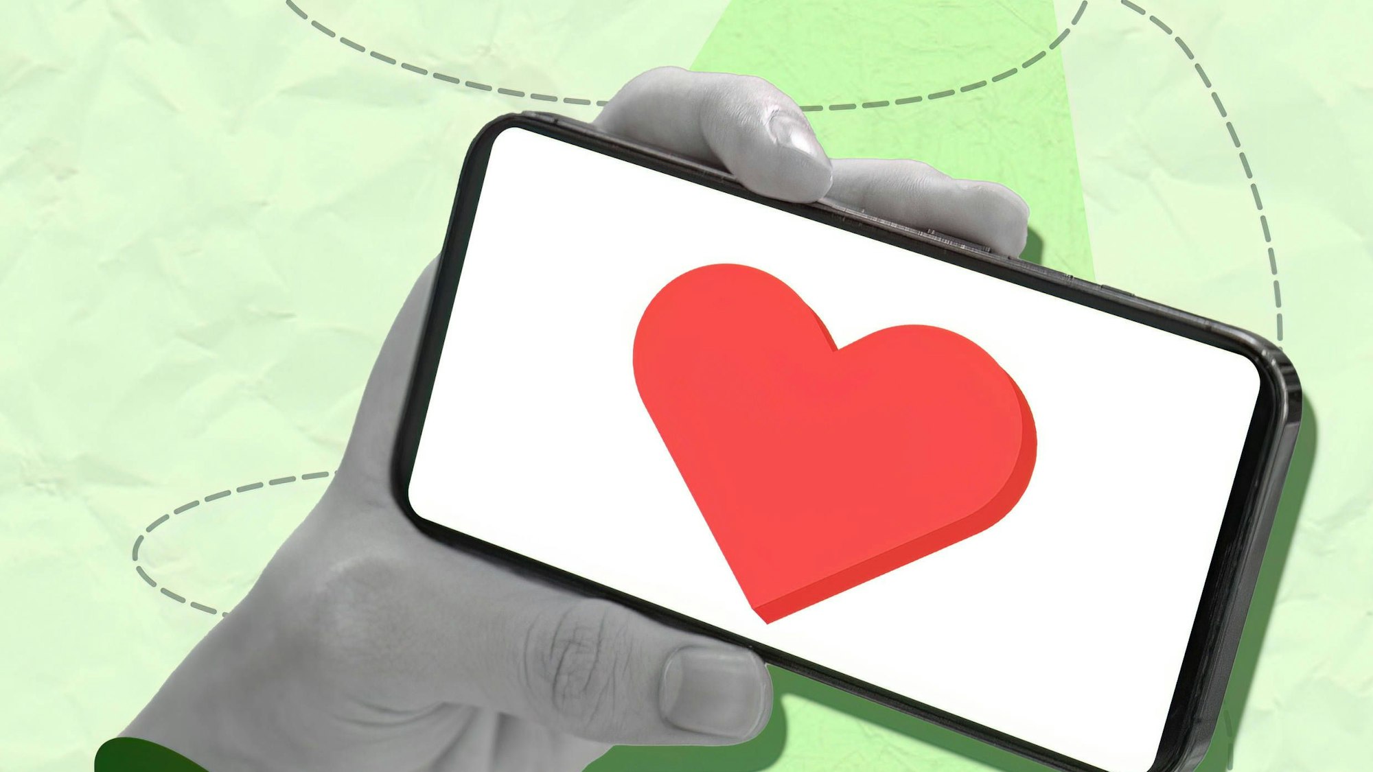 Eine Hand hält ein Smartphone mit Herz-Symbol