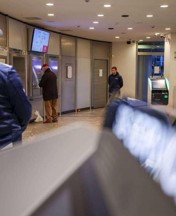 Mitarbeiter einer Sicherheitsfirma stehen im nun wieder geöffneten SB-Bereich der Sparkassenfiliale, in dem sich Kunden nun wieder Bargeld und Kontoauszüge holen können. Gut zwei Wochen nach dem Millionen-Einbruch ist das Foyer der Sparkasse Gelsenkirchen wieder offen.