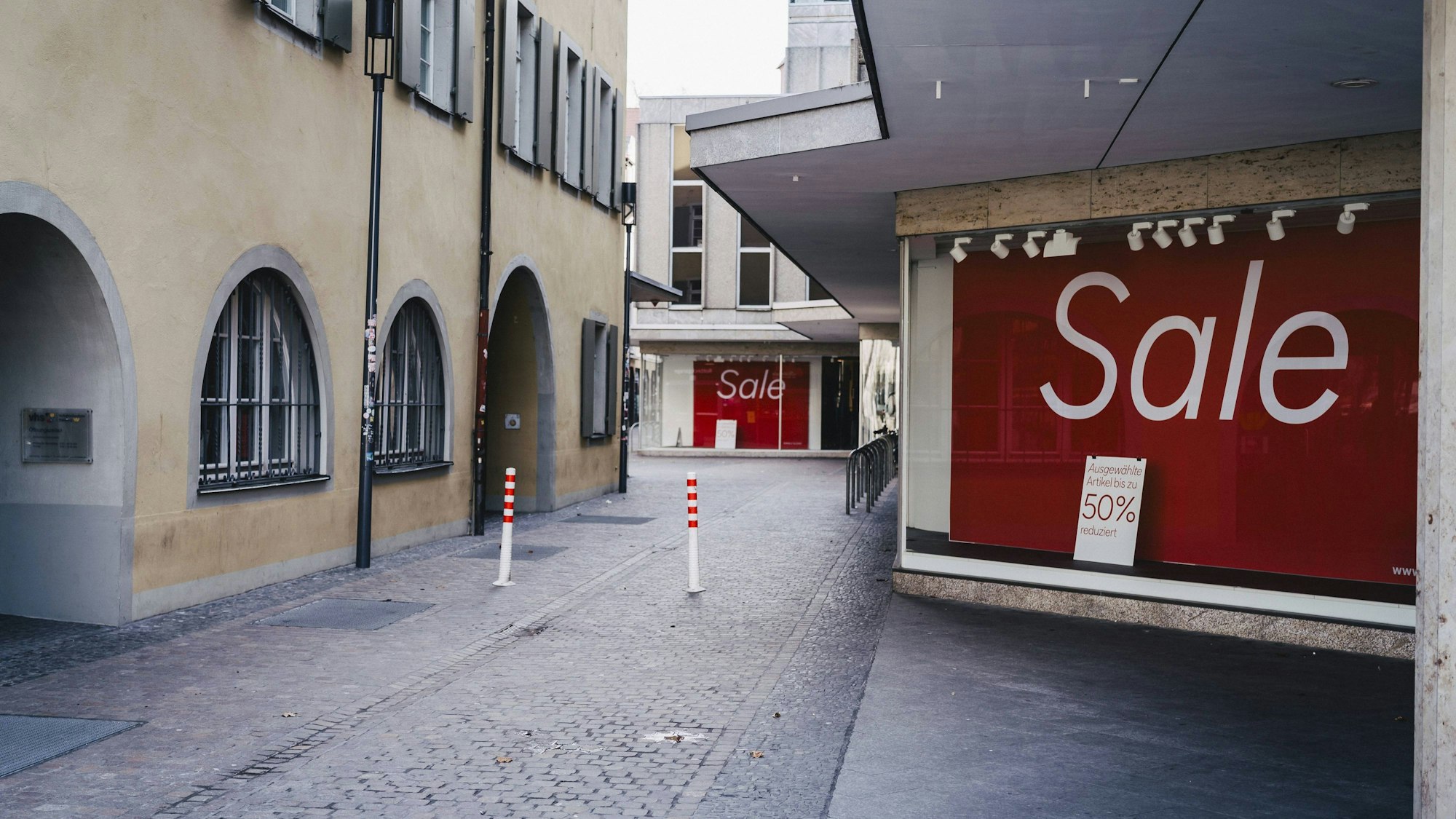 Leere Straße mit Gebäuden und Verkaufsschildern