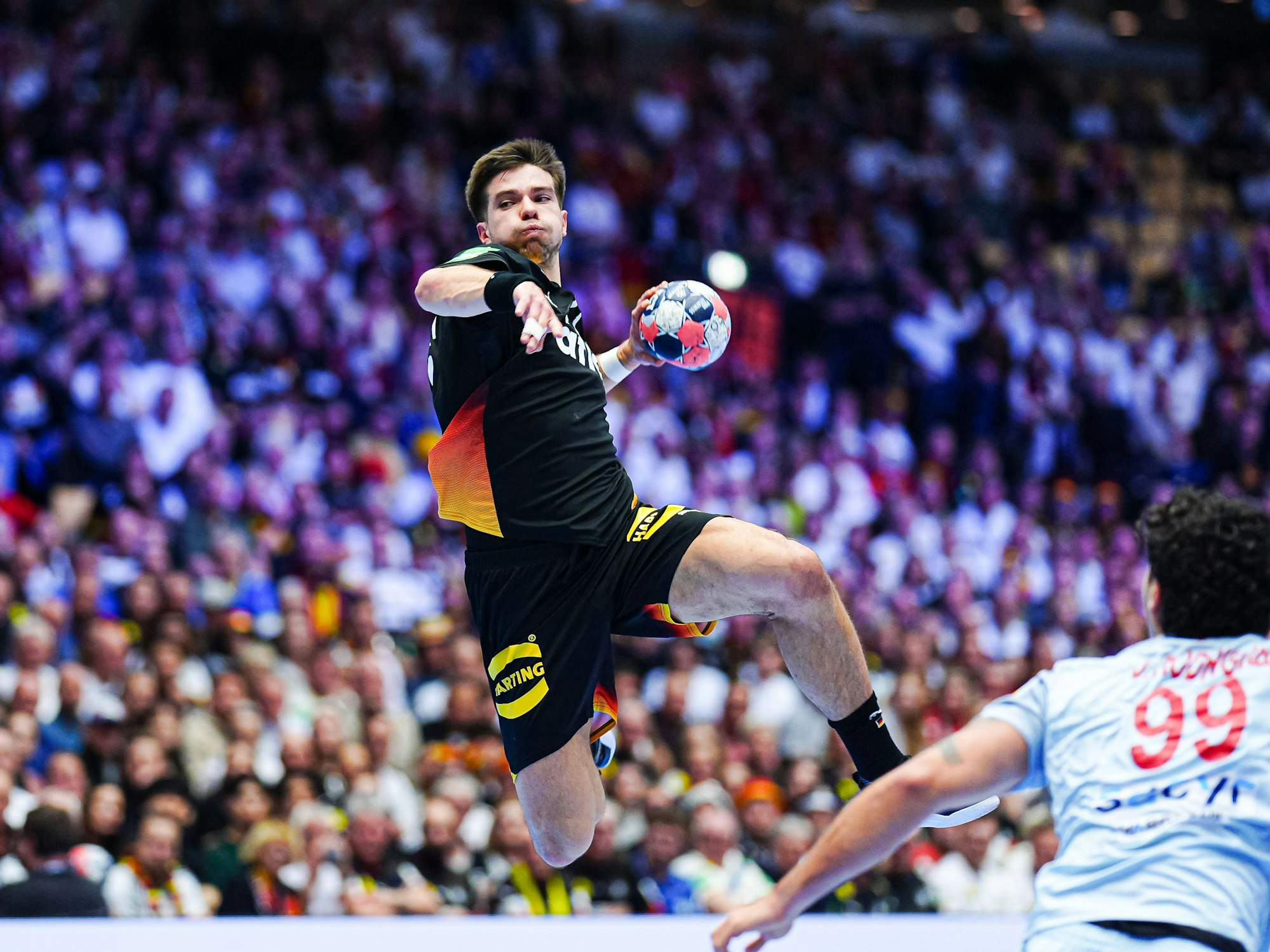 Renars Uscins steht beim Wurf in der Luft.