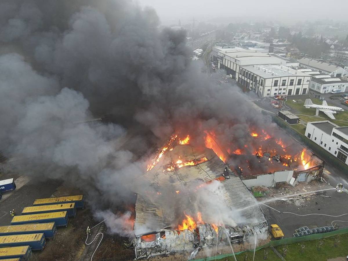 Einsatzkräfte bekämpfen den Brand einer Lagerhalle in Hürth.