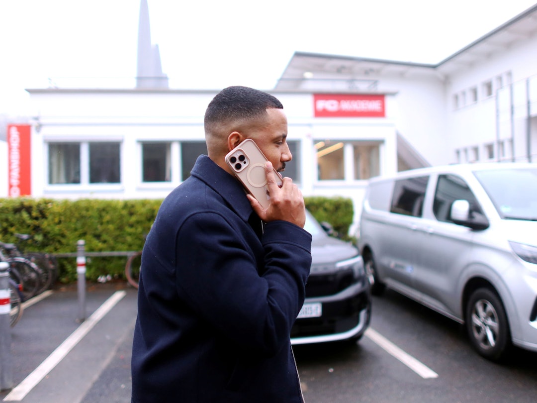 Der Spielerberater Cedric Mferi von Fynn Schenten kommt zum Geißbockheim und telefoniert.