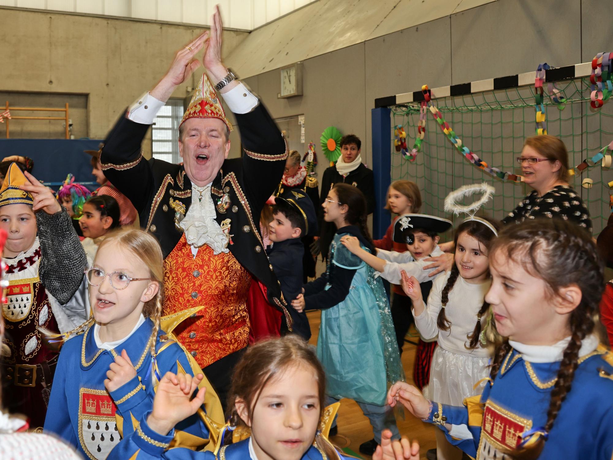 Christoph Kuckelkorn feiert mit den Kindern in der Turnhalle.
