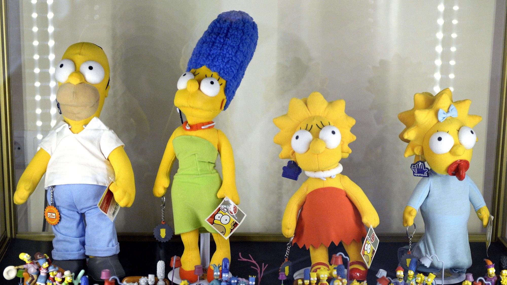Vier gelbe Plüschfiguren, die eine Familie mit Vater, Mutter und zwei Kindern darstellen.