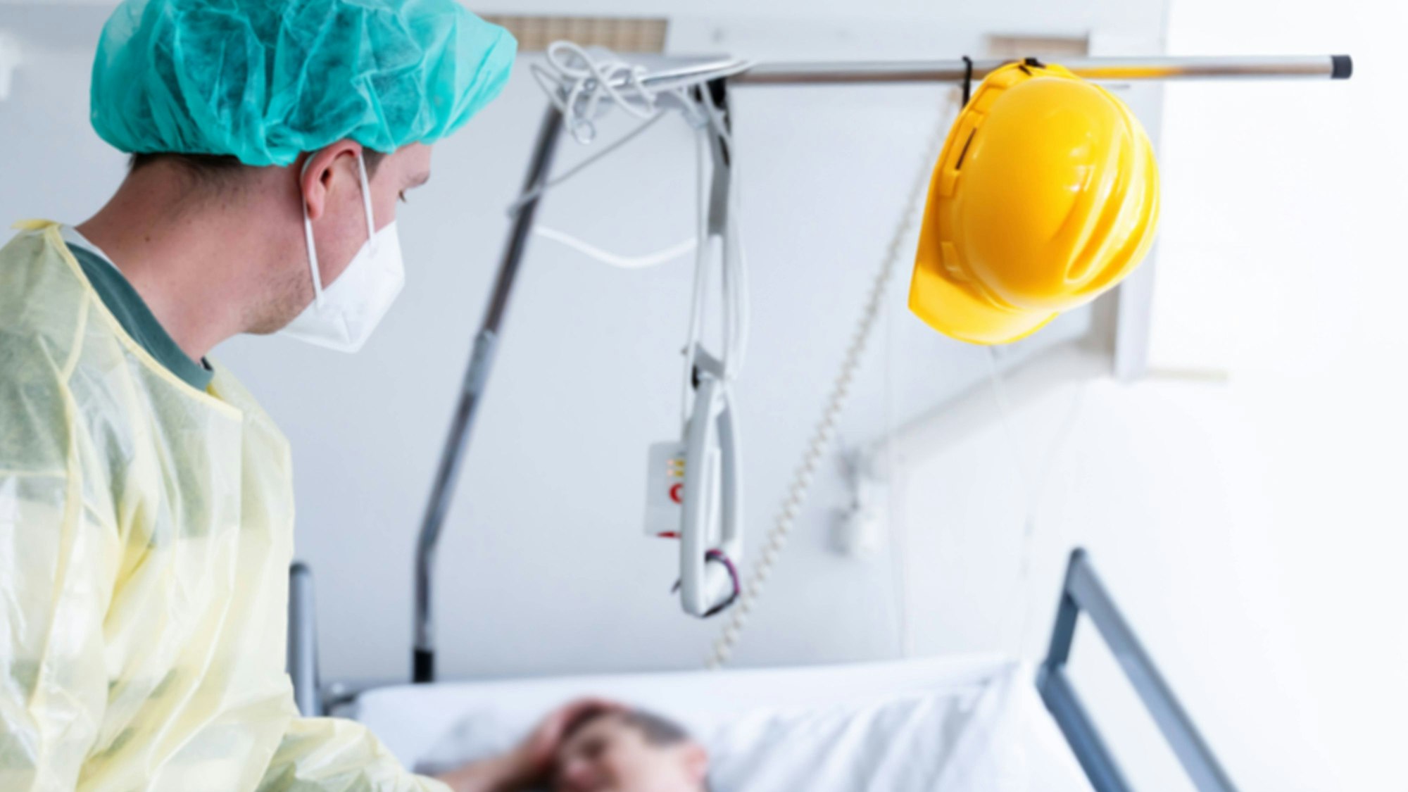 Arbeitsunfall: Pflegekraft, Patient und Bauhelm