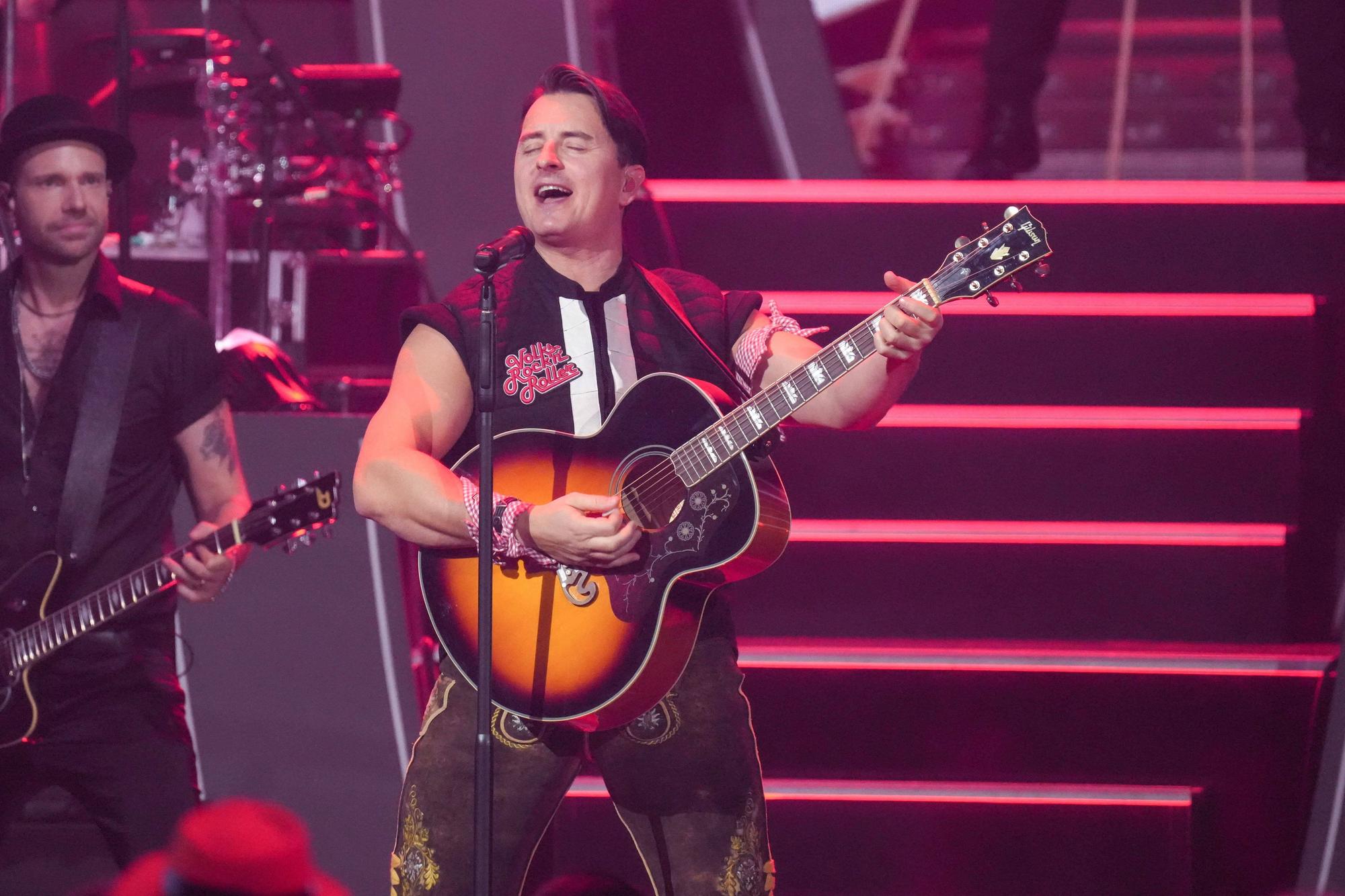 Sänger Andreas Gabalier singt und spielt Gitarre.