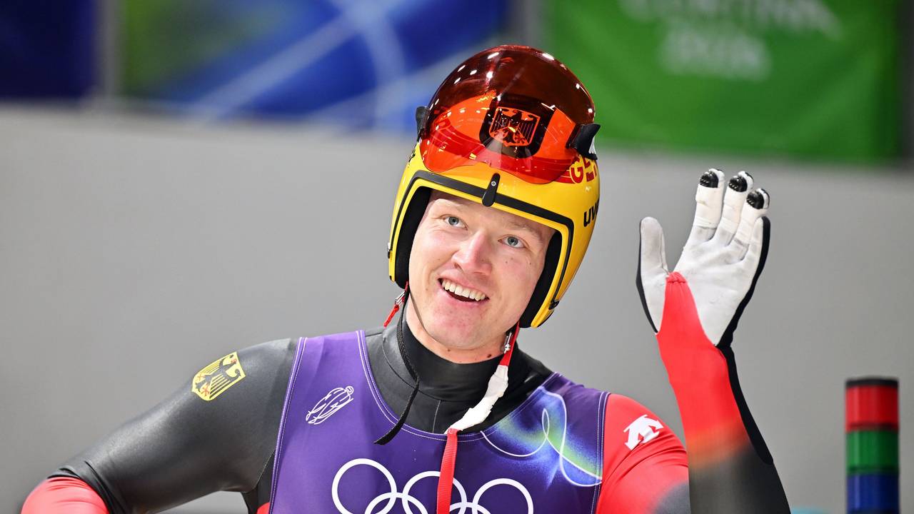 Rennrodler Max Langenhan winkt lächelnd den Fans zu.