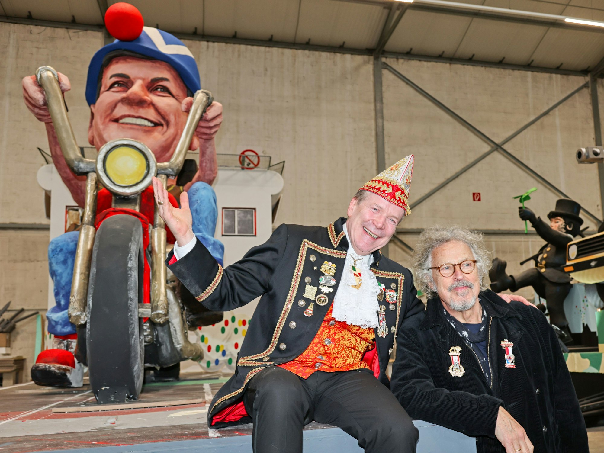 Christoph Kuckelkorn mit Wolfgang Niedecken vor einem Wagen.