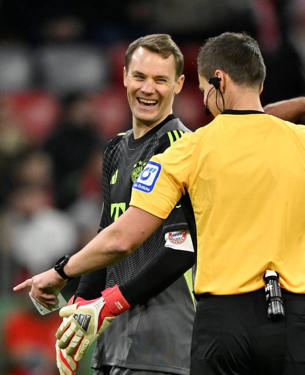 Bayern-Torwart Manuel Neuer lacht mit Schiedsrichter Daniel Siebert.