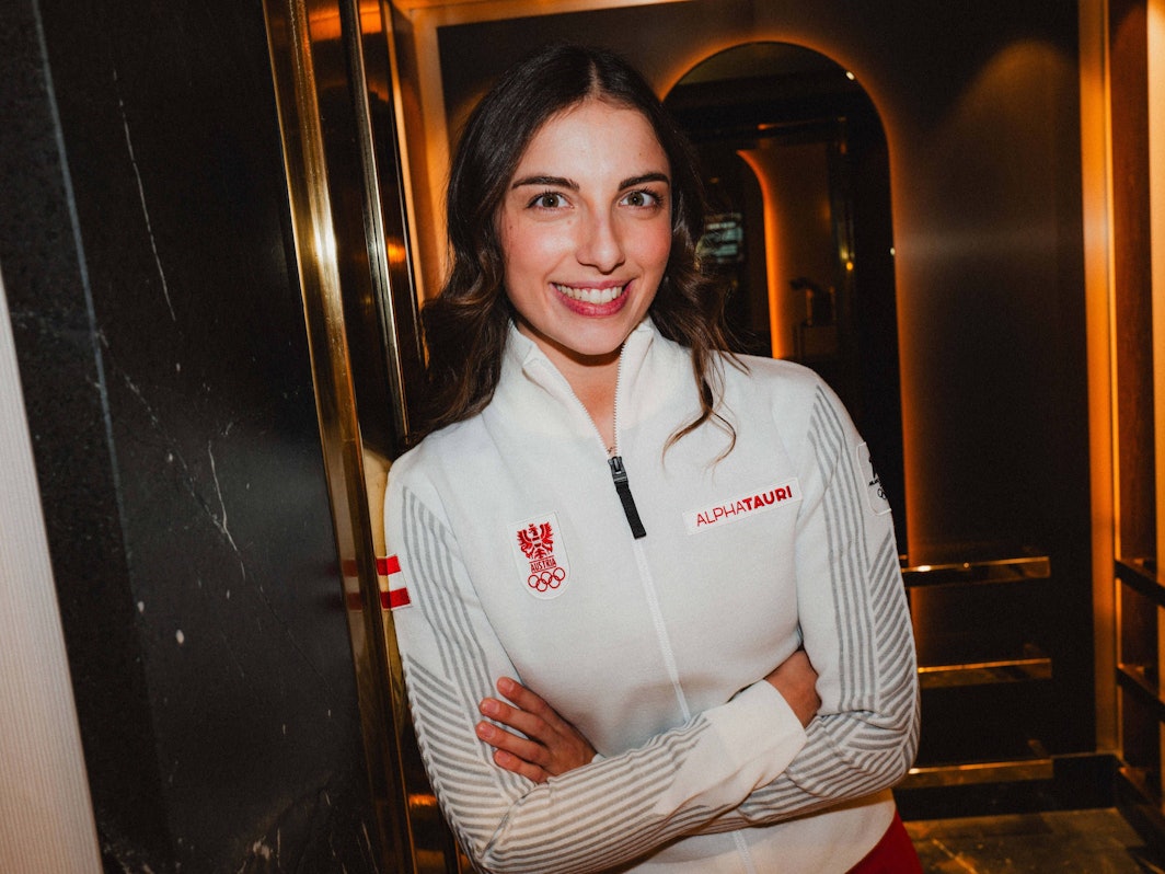 Rodlerin Hannah Prock lächelt mit verschränkten Armen in die Kamera.