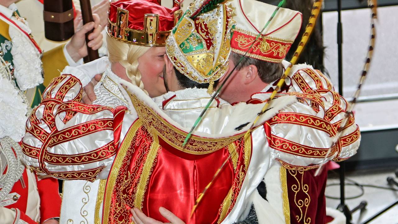Das Kölner Dreigestirn umarmt sich auf der Bühne.