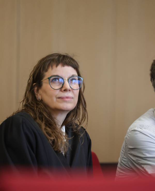 Rechtsanwältin Hannah Milena Piel (l) sitzt neben ihrem Mandanten, der sich einen Aktenordner vor das Gesicht hält, im Prozess um die Ermordung eines Professors im Jahr 1984 in Hilden. Der „Cold Case“ konnte nach Jahrzehnten durch einen DNA-Treffer aufgeklärt werden. Angeklagt ist ein 62-Jähriger Mann, der aus Italien an die deutsche Justiz ausgeliefert wurde.