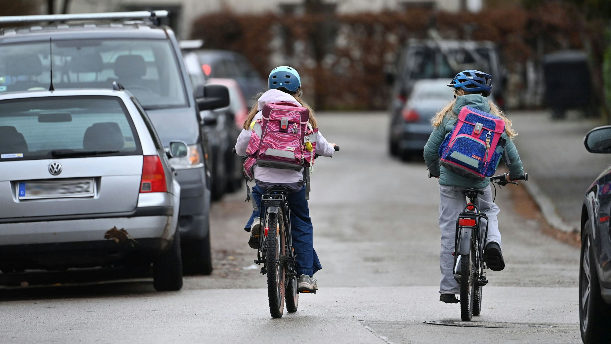 Zwei Schüler auf Fahrrädern mit Schulranzen