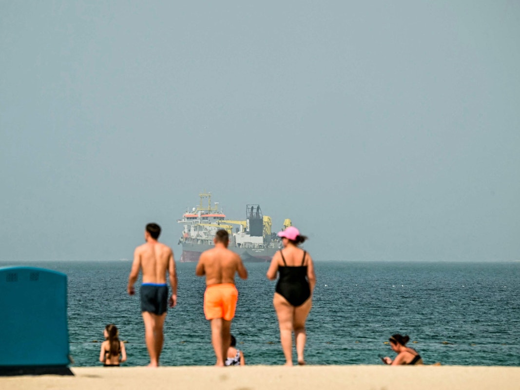 Urlauber und Urlauberinnen genießen die Sonne am Strand in Dubai. Der AFP-Fotograf machte das Foto am 2. März 2026.