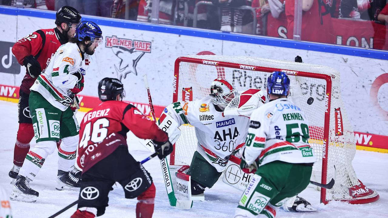 Kevin Niedenz (2.v.l.) schießt den Puck ins Tor.