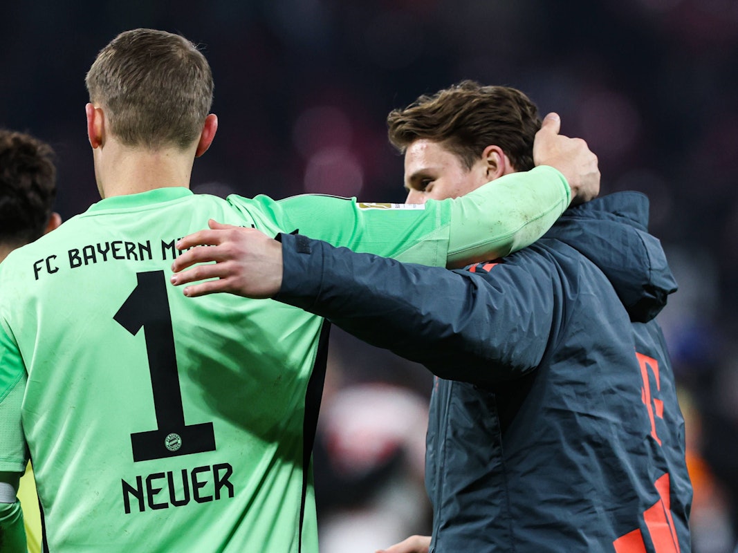 Manuel Neuer und Jonas Urbig umarmen sich nach einem Spiel.