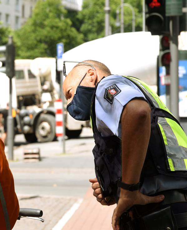 Ein Polizist spricht mit einem Essenslieferanten.
