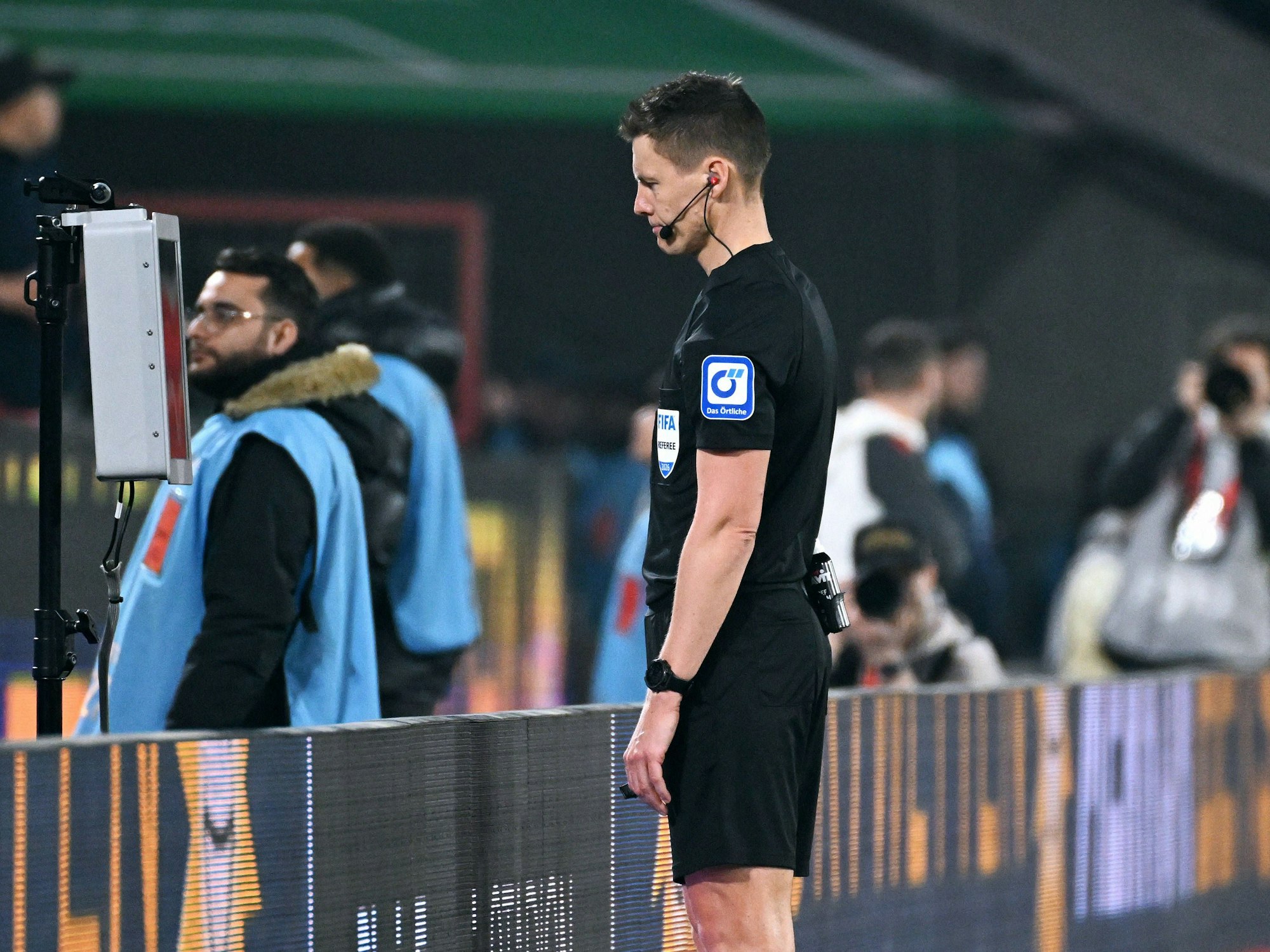 Schiedsrichter Daniel Siebert guckt sich eine strittige Szene an.