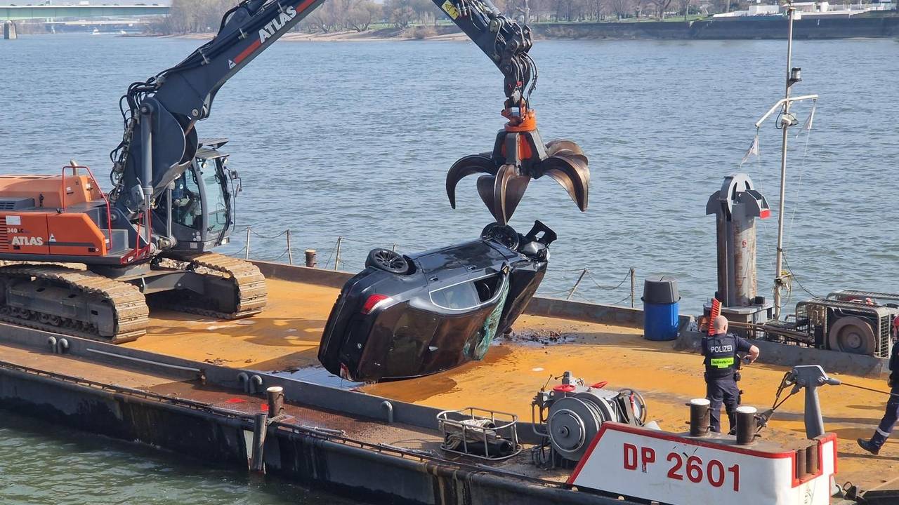Ein Pkw liegt seitlich auf dem Deck eines Schiffes.