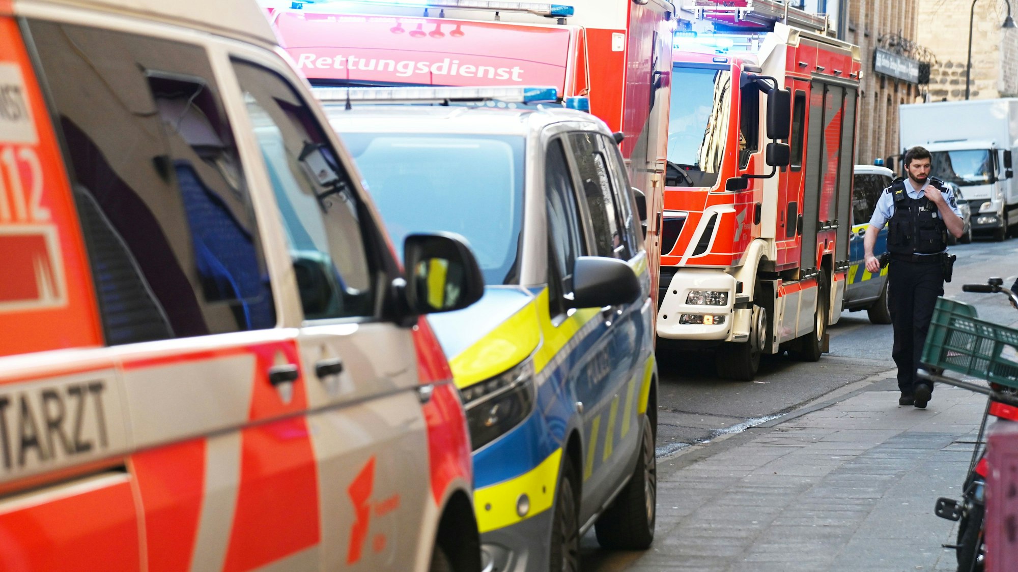 Einsatzfahrzeuge von Polizei, Feuerwehr und Rettungsdienst stehen auf einer Straße.