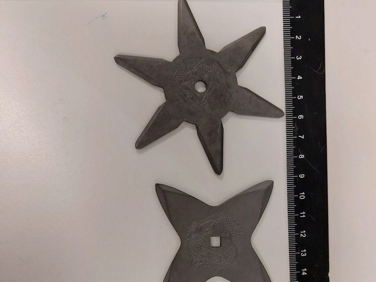 Drei Wurfsterne liegen auf einem Tisch.