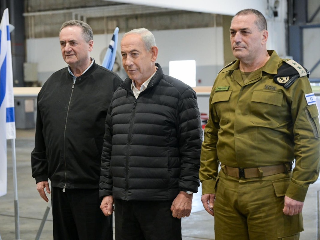 Der israelische Ministerpräsident Benjamin Netanjahu steht zwischen zwei anderen Männern.