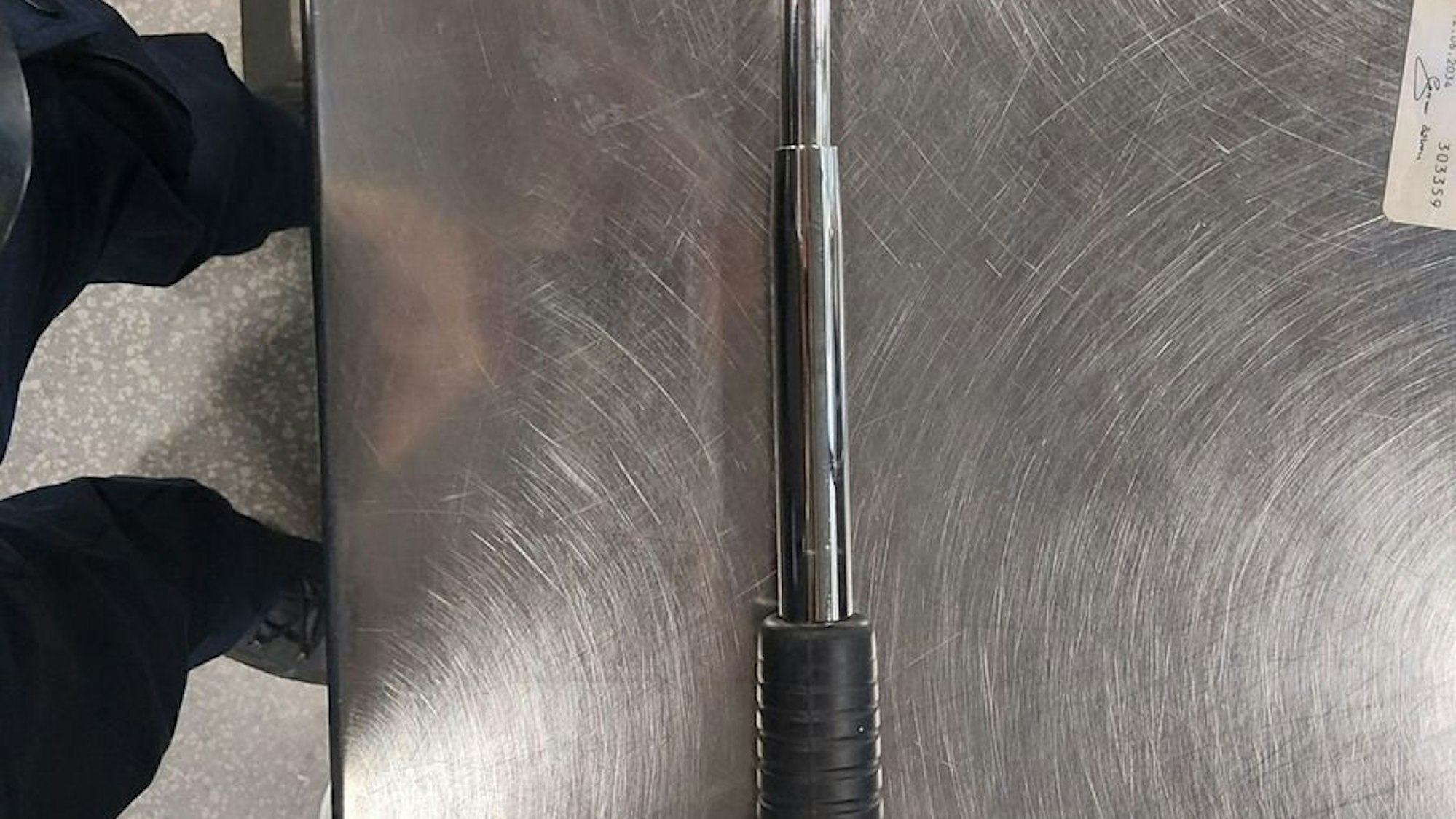 Ein Teleskopschlagstock liegt auf dem Boden.