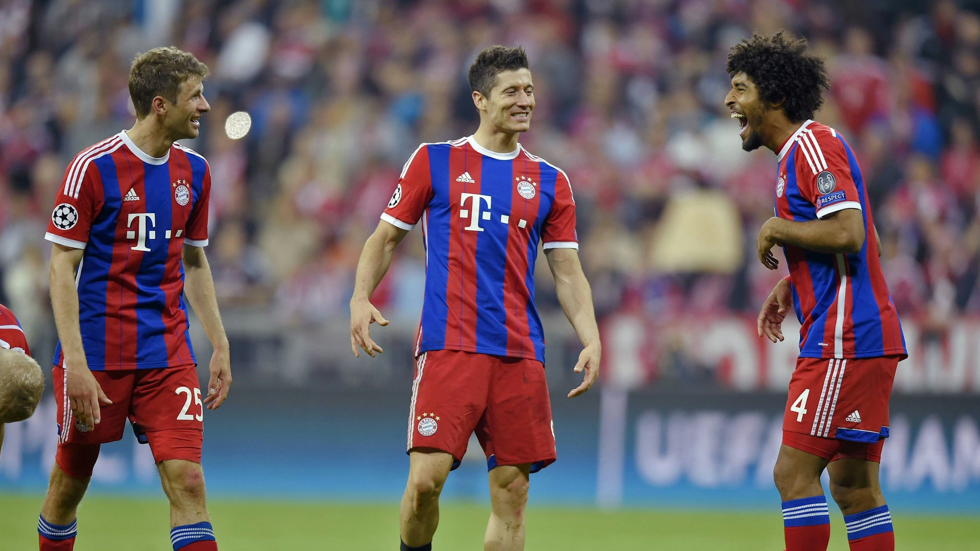 Thomas Müller, Robert Lewandowski (M.) und Dante (r.) unterhalten sich auf dem Feld.