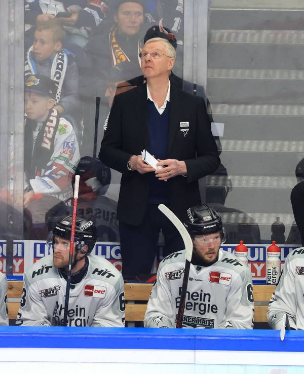 Haie-Cheftrainer Kari Jalonen steht bei seinen Spielern am Rande der Eisfläche.