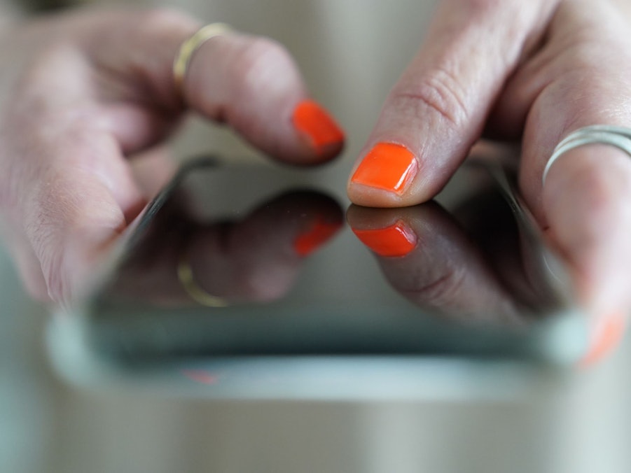 Eine Frau tippt auf einem Smartphone