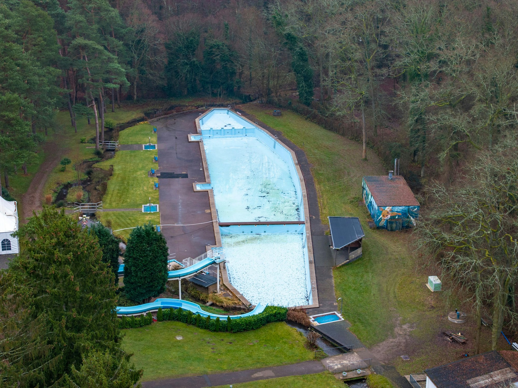 Das Waldbad Dünnwald, hier im Dezember 2025, stand vor dem Aus. Eine Sanierung kostet mindestens acht Millionen Euro. Nun ist das Freibad durch den Bund gerettet.