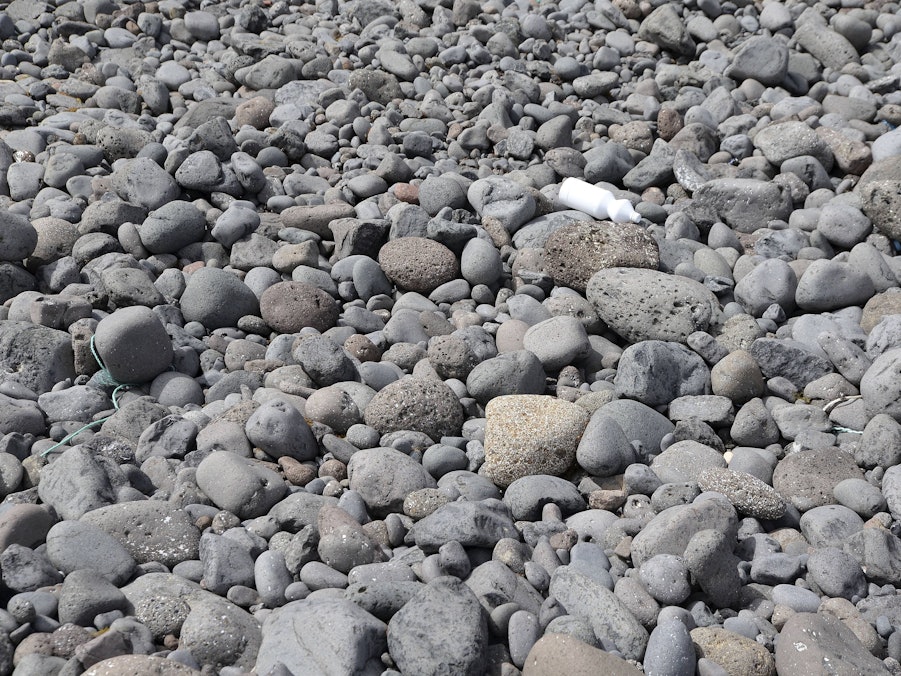 Steine und Müll am Strand