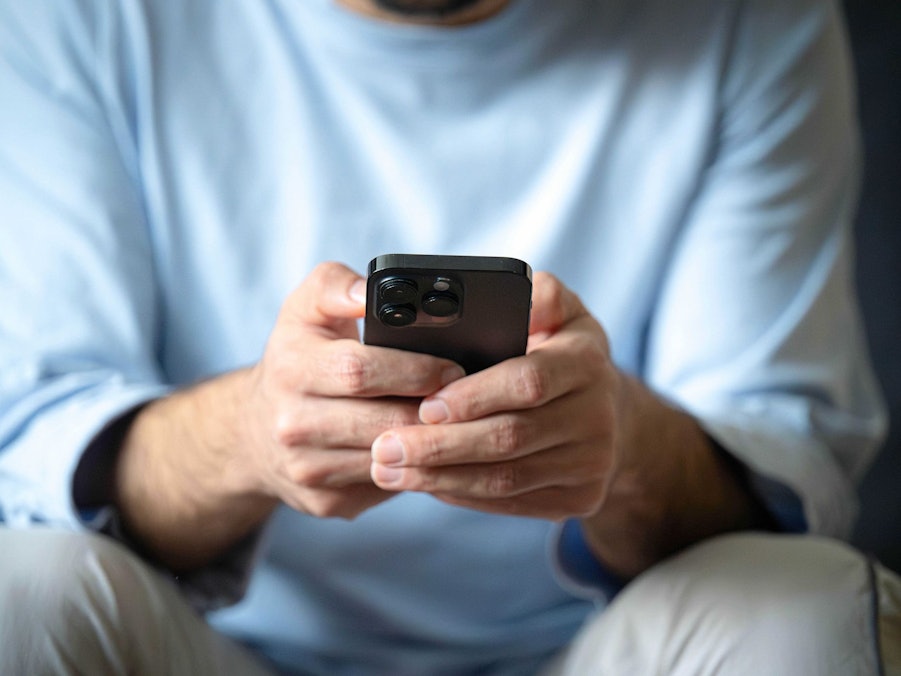 Ein Mann tippt auf einem Smartphone