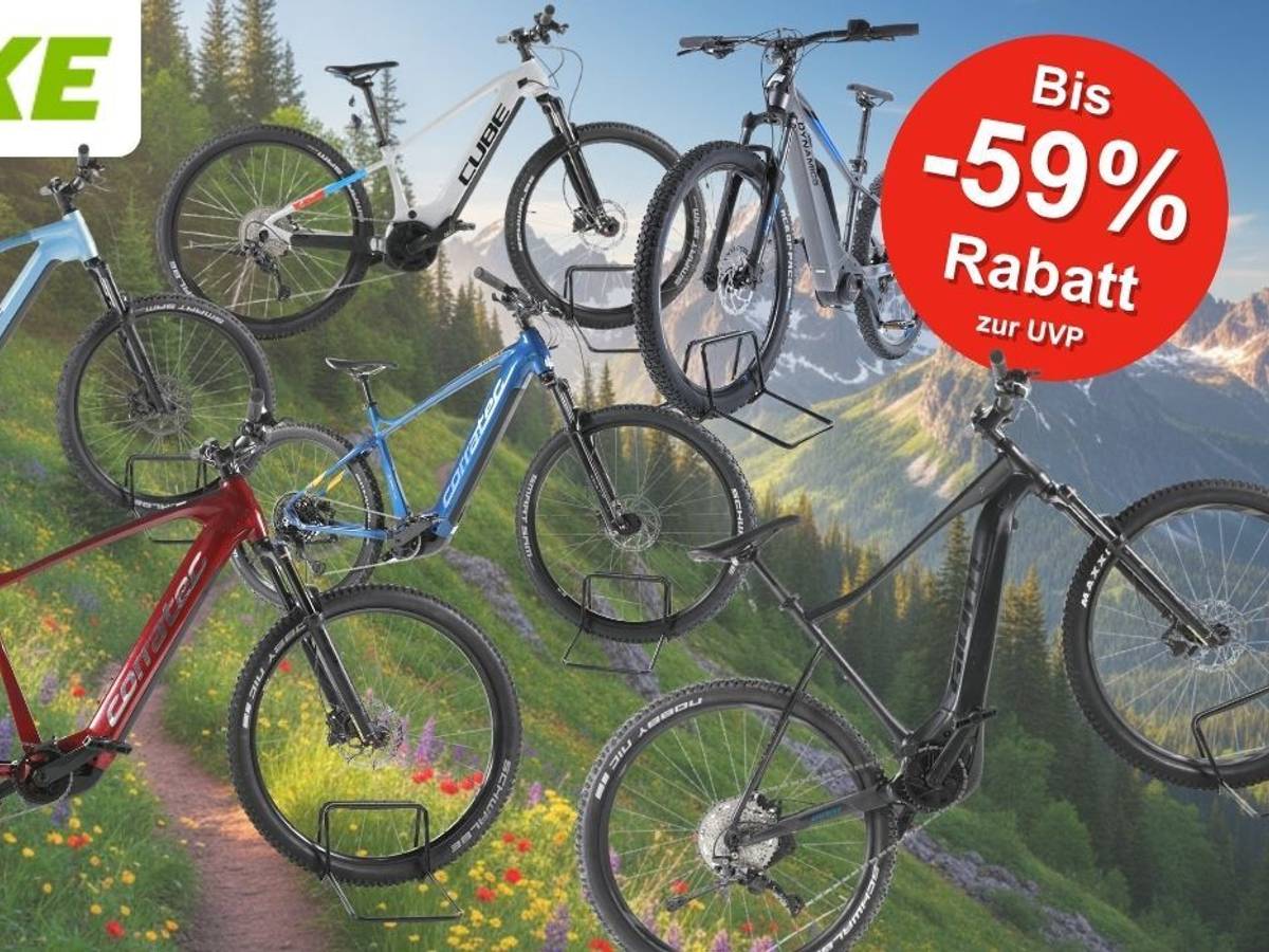 Fünf E-Mountainbikes der Marken Cube, Corratec, KTM und mehr in verschiedenen Farben (hellblau, weiß-schwarz, rot, blau, schwarz), präsentiert vor einer alpinen Berglandschaft mit Blumenwiese. Ein roter Kreis-Badge oben rechts zeigt „Bis -59 % Rabatt zur UVP". Logo von REBIKE oben links.