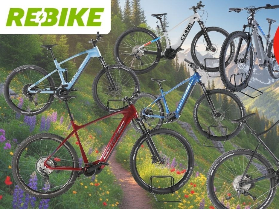 Fünf E-Mountainbikes der Marken Cube, Corratec, KTM und mehr in verschiedenen Farben (hellblau, weiß-schwarz, rot, blau, schwarz), präsentiert vor einer alpinen Berglandschaft mit Blumenwiese. Ein roter Kreis-Badge oben rechts zeigt „Bis -59 % Rabatt zur UVP". Logo von REBIKE oben links.