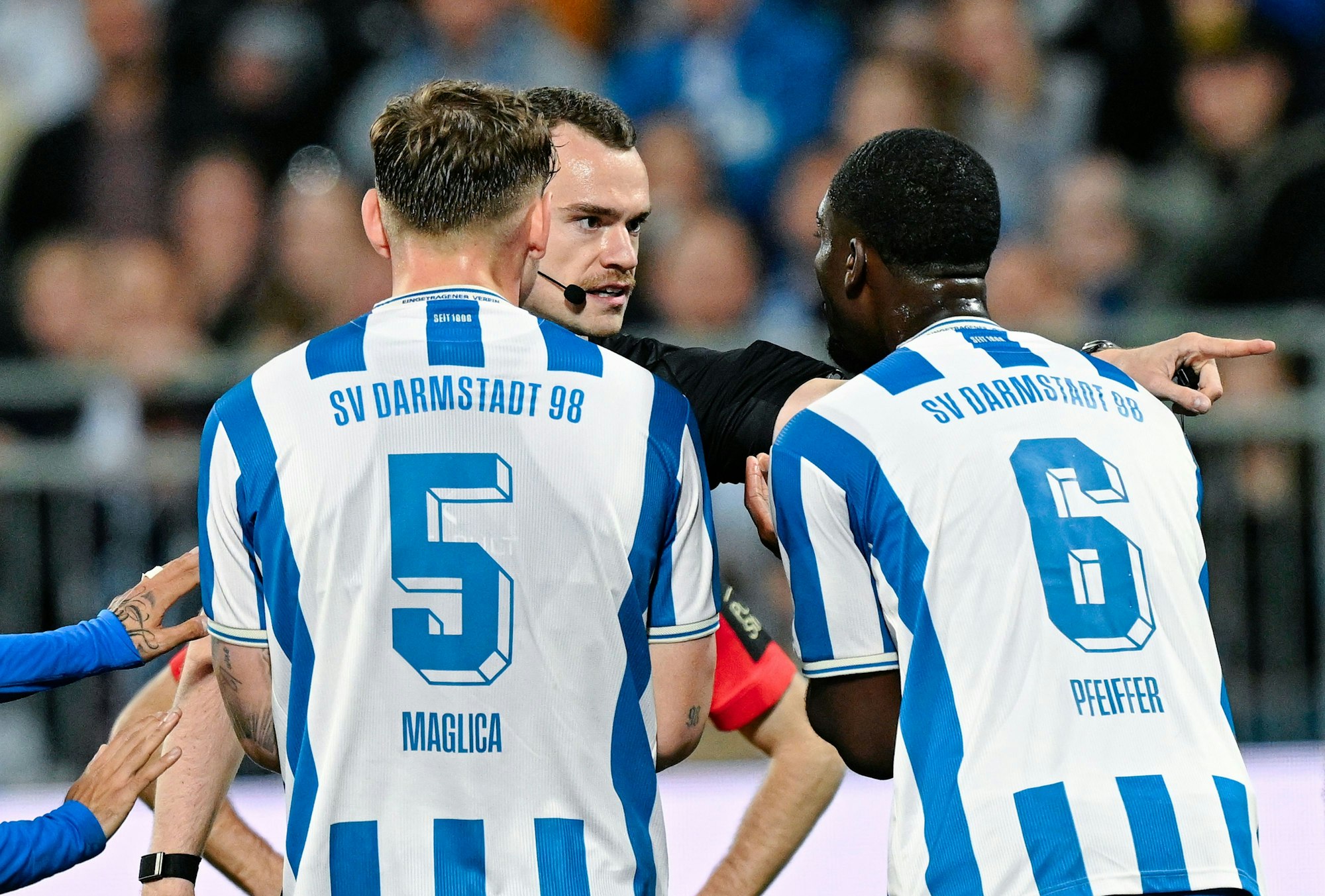 Die Spieler von Darmstadt 98 diskutieren mit Schiedsrichter Richard Hempel.