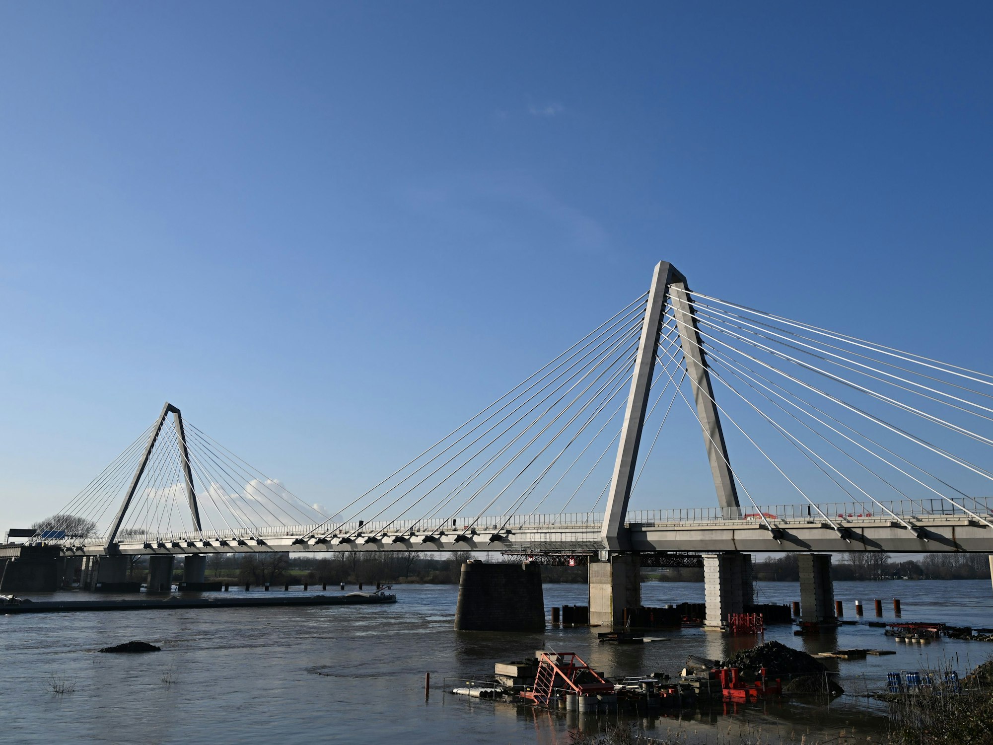 Ein Schiff fährt auf dem Rhein unter der Leverkusener Brücke.