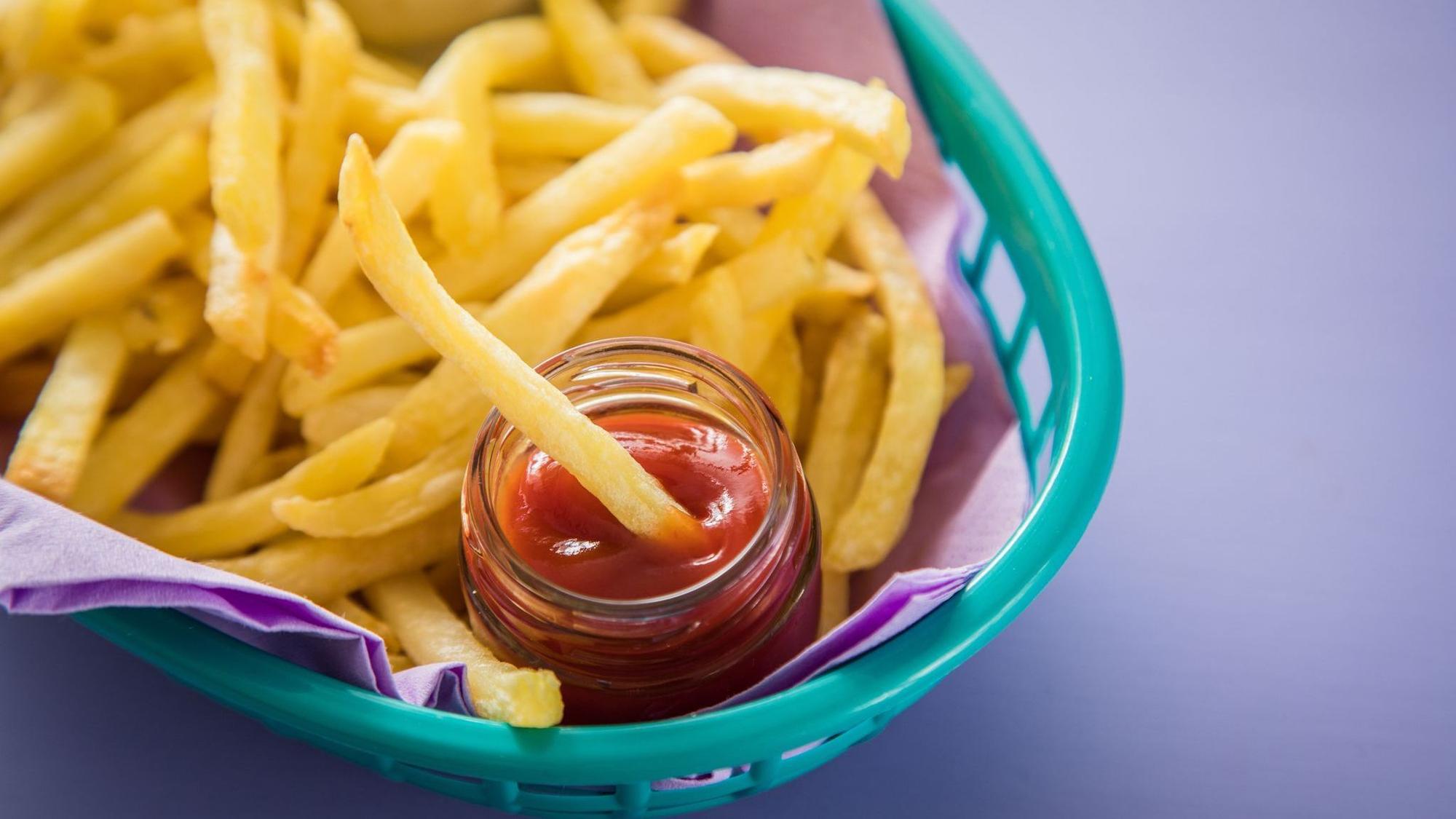 Pommes mit Ketchup liegen in einem Körbchen