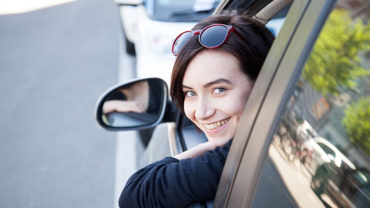 Eine junge Frau schaut aus einem Autofenster