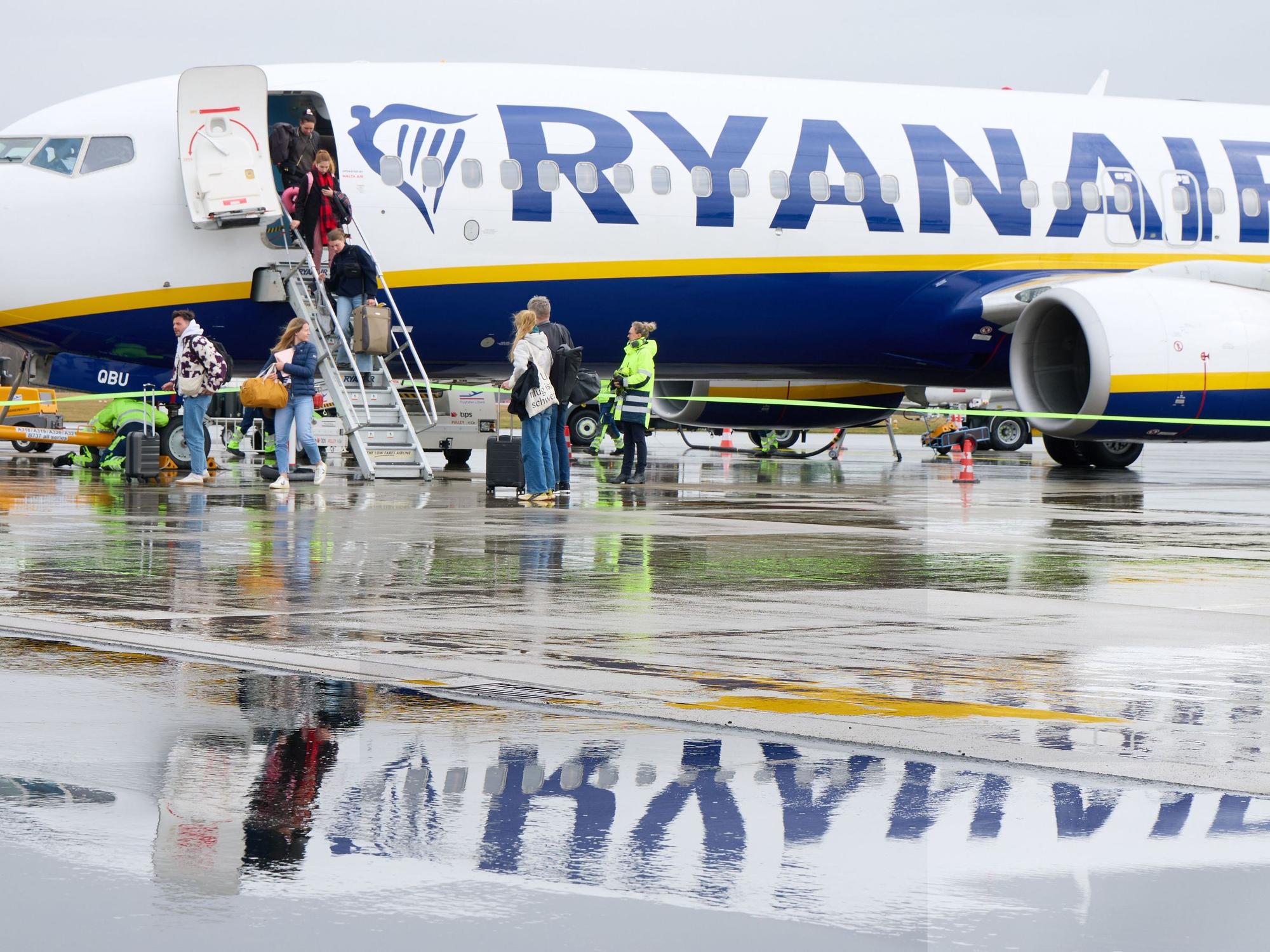 Passagiere aus Mallorca verlassen nach der Landung auf Flughafen Lübeck eine Boing 737-800 AS der Fluggesellschaft Ryanair.