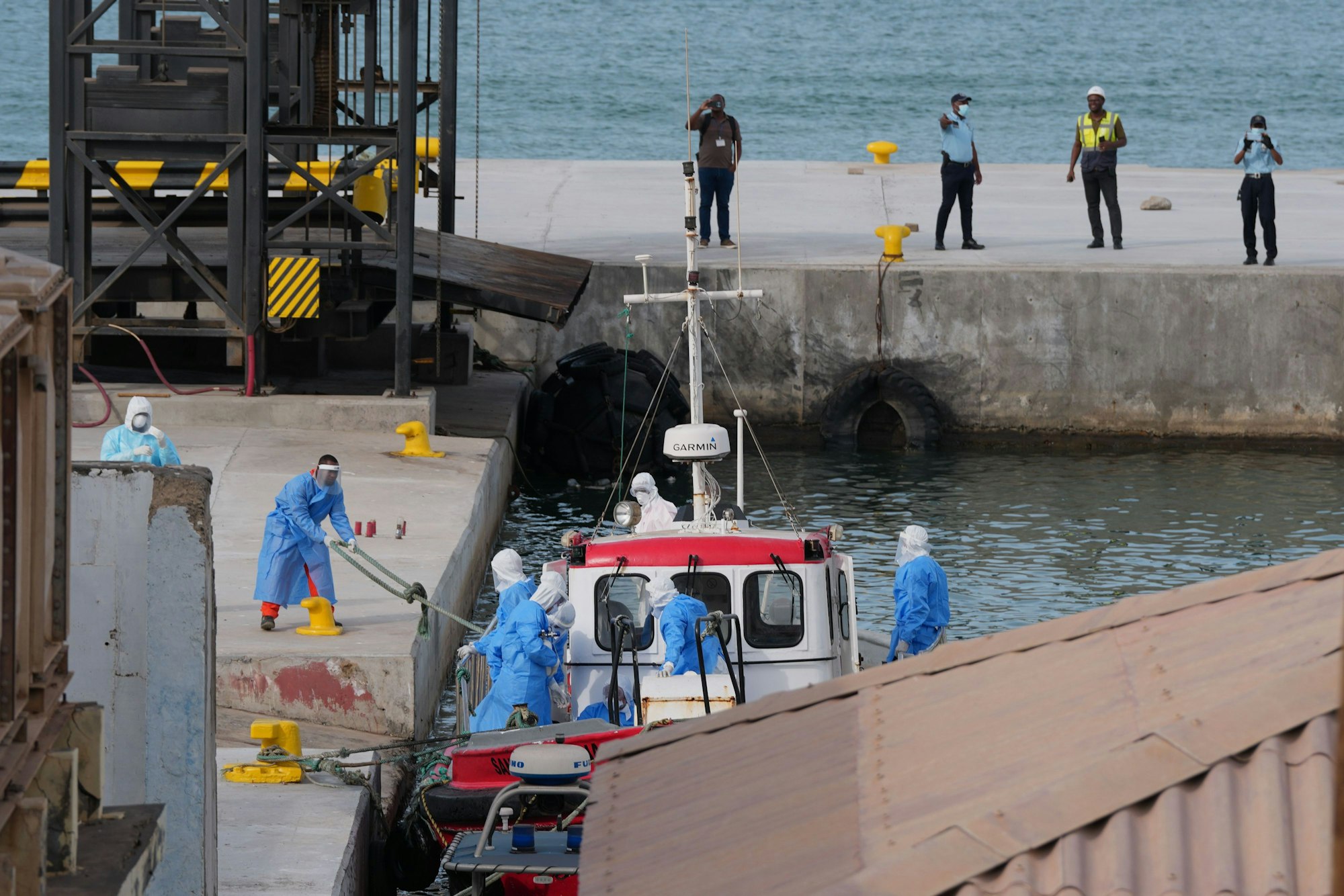 Gesundheitspersonal in Schutzkleidung evakuiert Patienten vom Kreuzfahrtschiff „Hondius“ in einem Hafen.